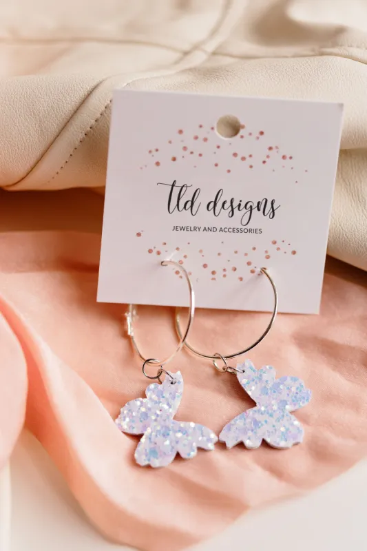 Iridescent Butterfly Hoops sold by Charming Charlie