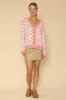 Bow tiled knit cardigan sold by Charming Charlie