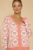 Bow tiled knit cardigan sold by Charming Charlie