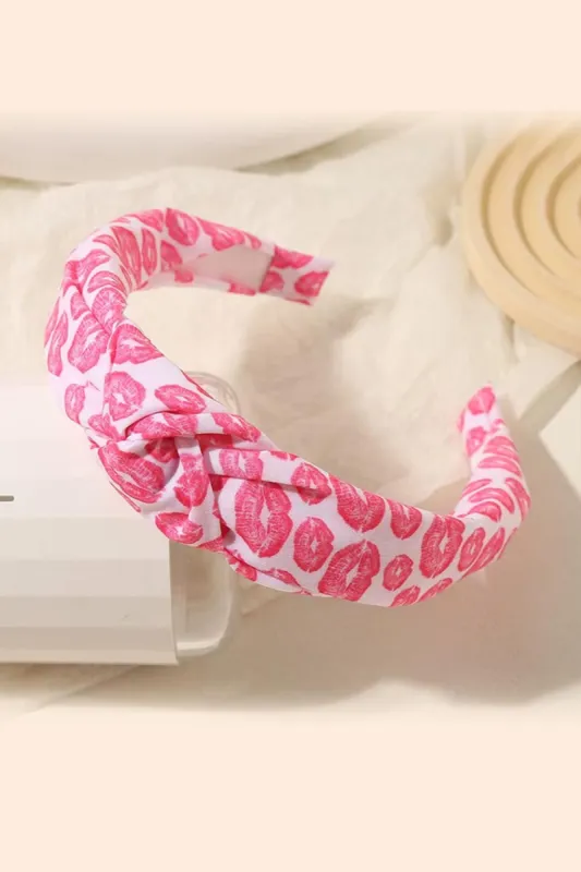 Ivory & Red Kiss Me Valentine's Top Knot Headband sold by Charming Charlie