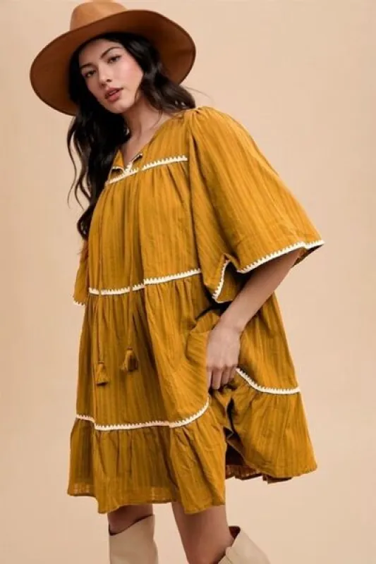 Annie Wear Tassel Contrast Trim Tie Neck Half Sleeve Tiered Dress sold by Charming Charlie