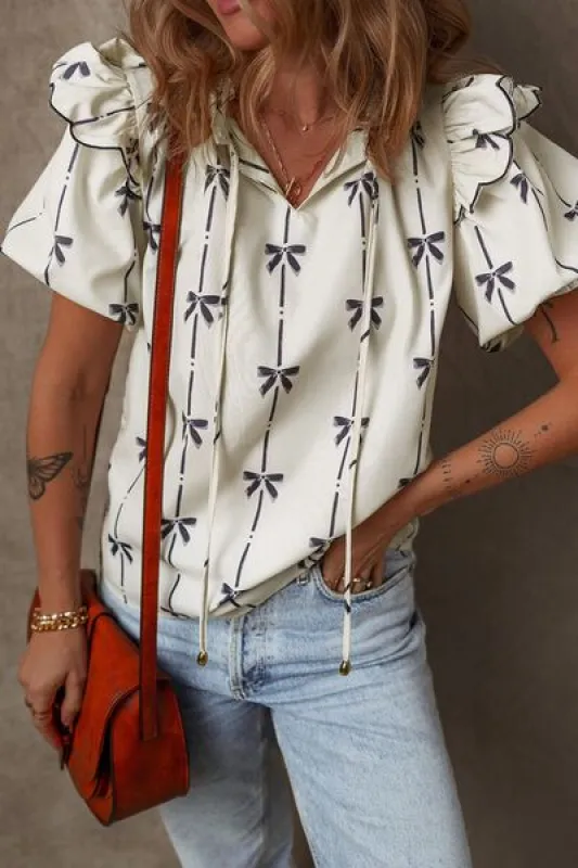 Bow Print Tie Neck Short Sleeve Blouse sold by Charming Charlie