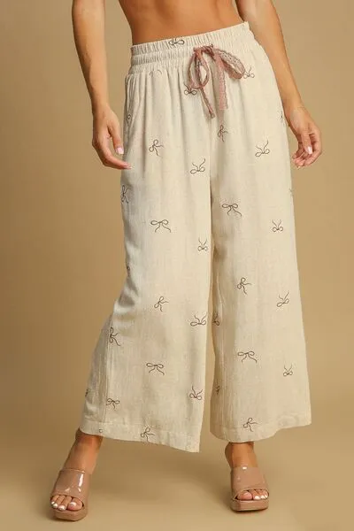 Umgee Full Size Lace Drawstring Embroidered Bow Wide Leg Pants Plus Size sold by Charming Charlie