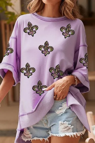Mardi Gras Sequin Fleur De Lis Patched Exposed Seam Oversize Top sold by Charming Charlie