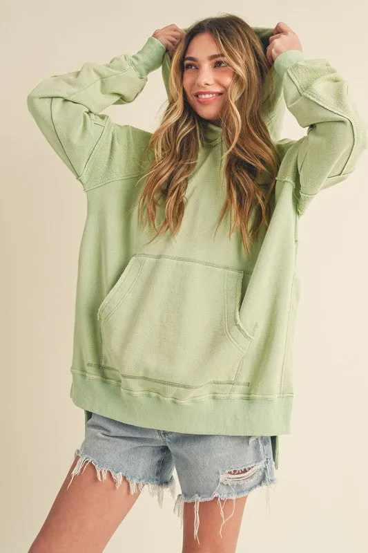 Aemi + Co Exposed Seam Side Slit Hoodie with Kangaroo Pocket sold by Charming Charlie