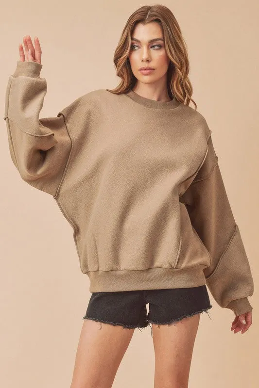 Aemi + Co Exposed Seam Round Neck Drop Shoulder Sweatshirt sold by Charming Charlie