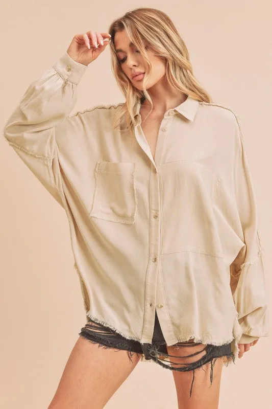 Aemi + Co Raw Edge Exposed Seam Collared Neck Long Sleeve Shirt sold by Charming Charlie
