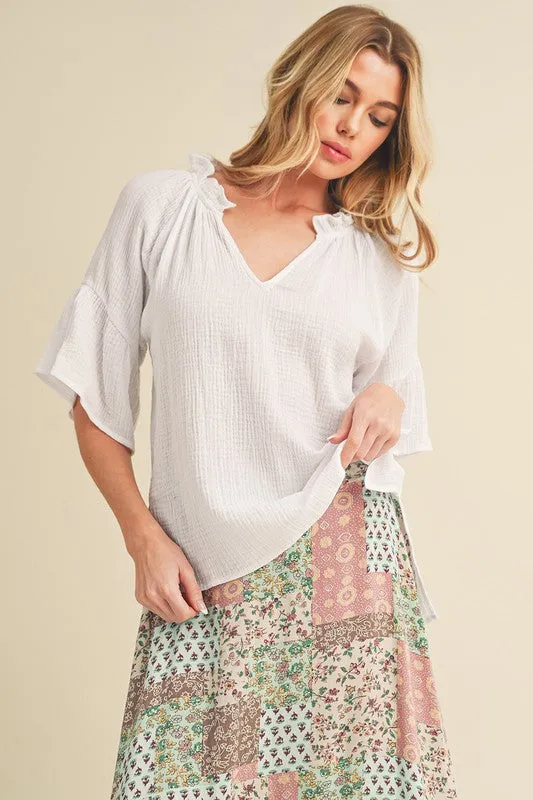 Aemi + Co Side Slit Notched Ruffled Half Sleeve Blouse sold by Charming Charlie
