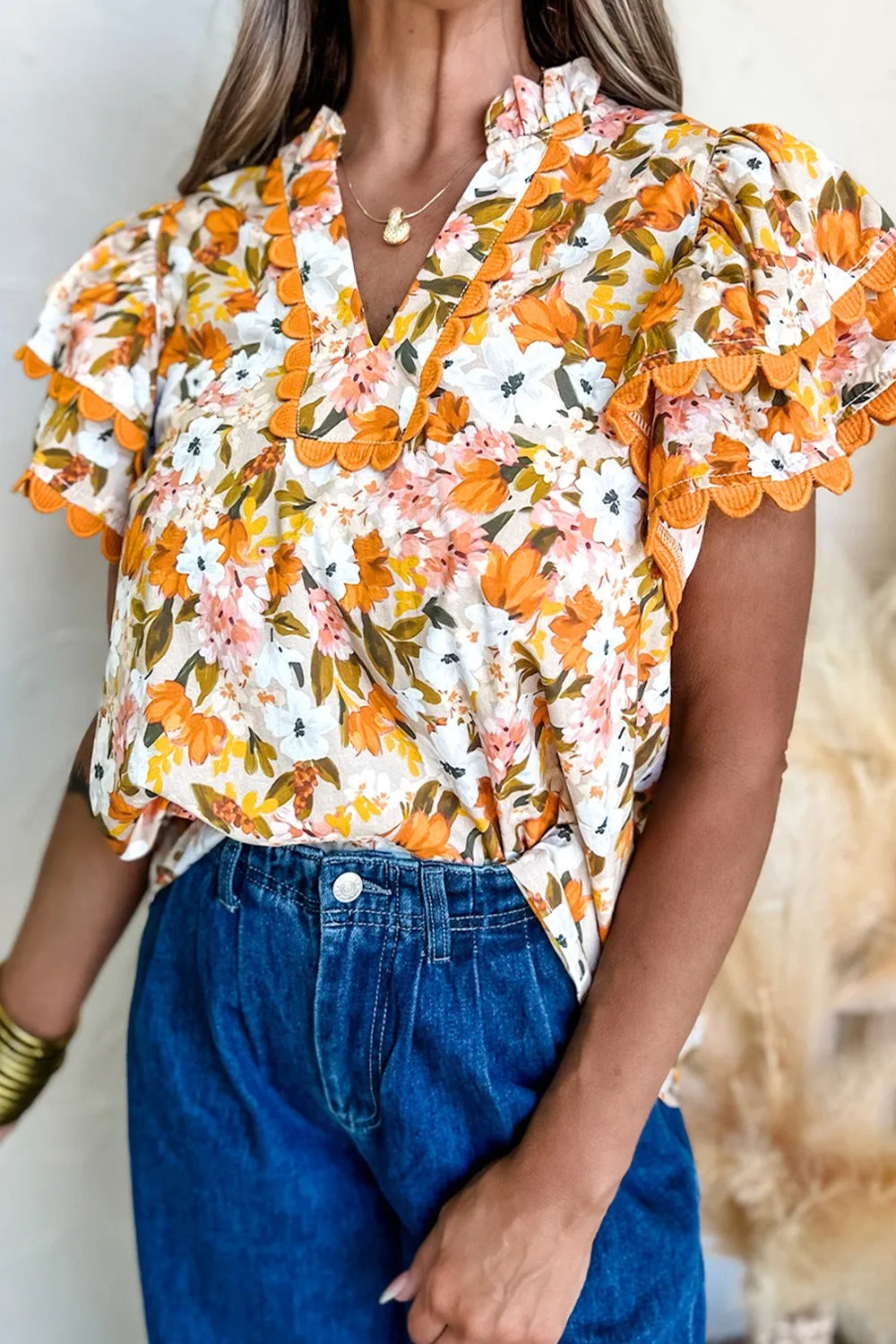 Ruffled Notched Short Sleeve Floral Blouse sold by Charming Charlie