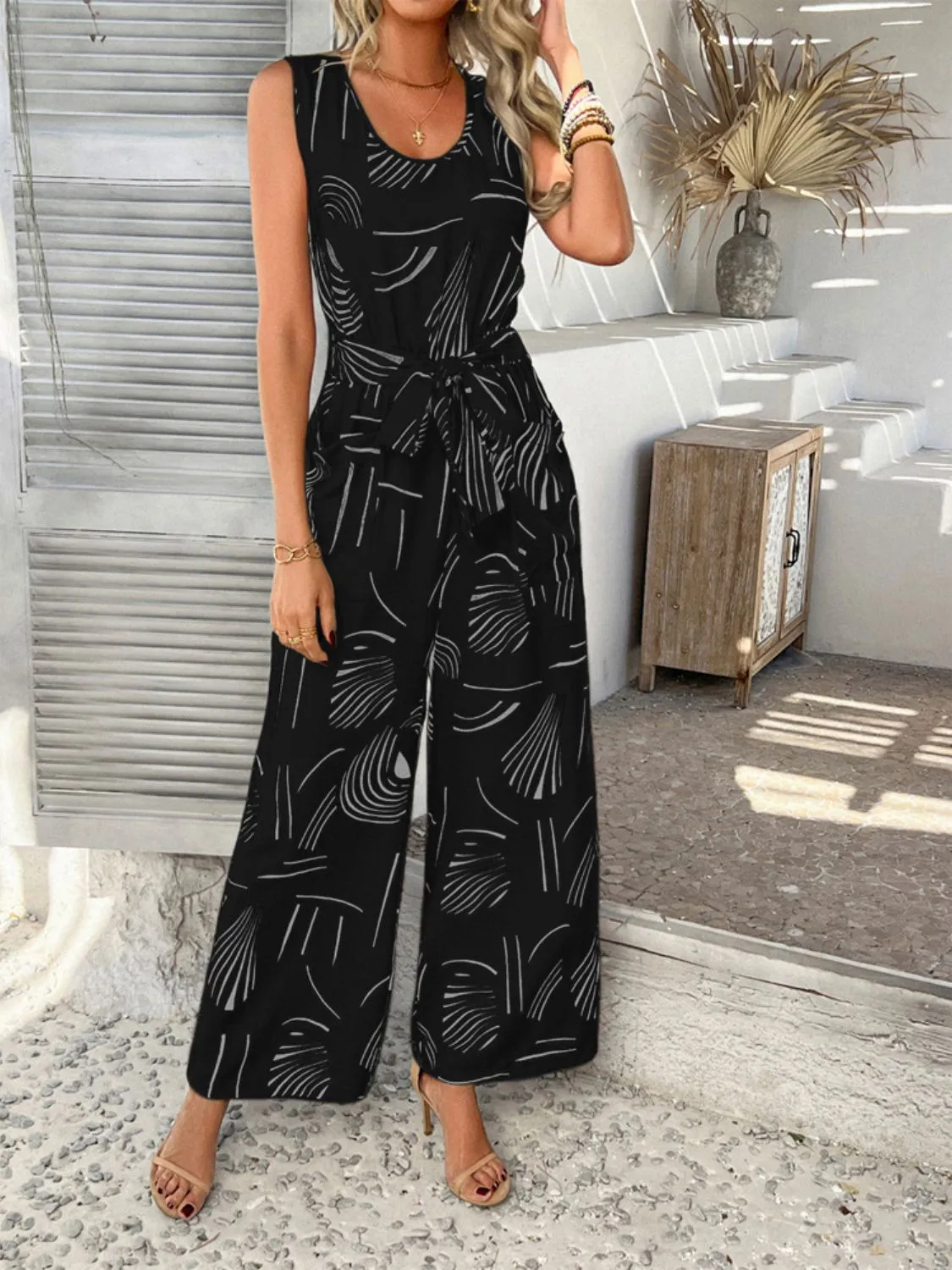Devine Printed Round Neck Sleeveless Tie Waist Jumpsuit sold by Charming Charlie product image thumbnail 4