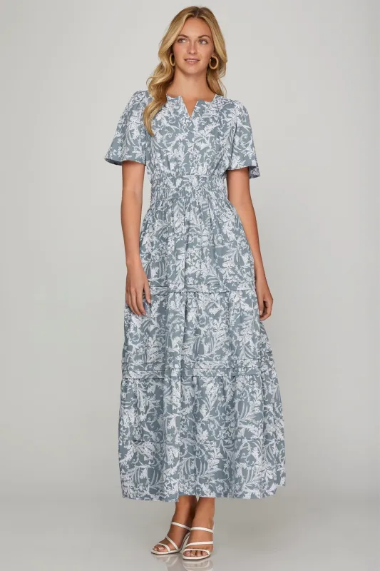 She + Sky Printed Notched Woven Tiered Pintuck Maxi Dress with Side Pockets sold by Charming Charlie