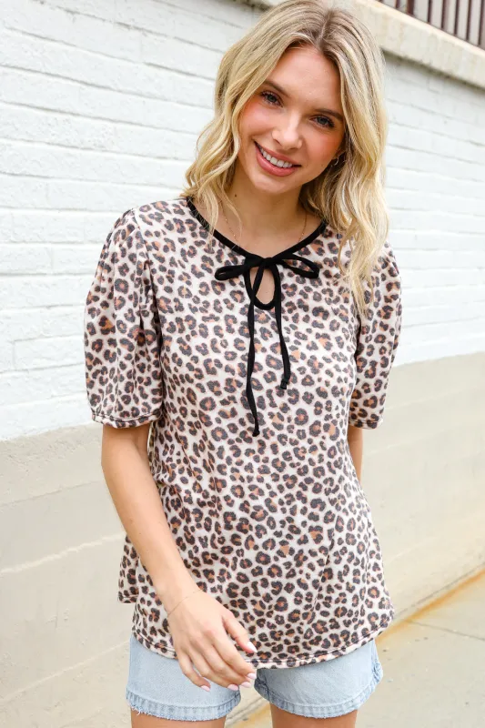 Everyday Animal Print Collar Notch Front Tie Knit Top sold by Charming Charlie