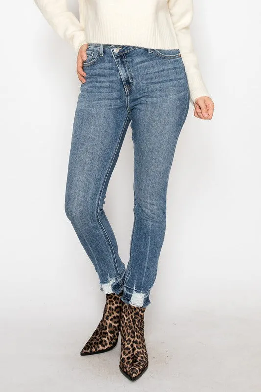 HIGH RISE CROSSOVER SKINNY JEANS sold by Charming Charlie