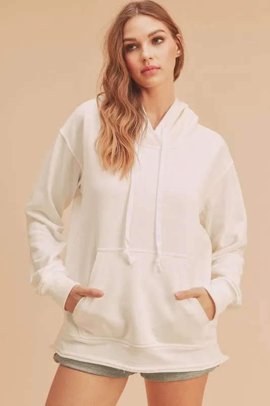 Aemi + Co Raw Hem Kangaroo Pocketed Drawstring Hoodie sold by Charming Charlie