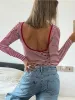 Striped long sleeve open back shirt sold by Charming Charlie