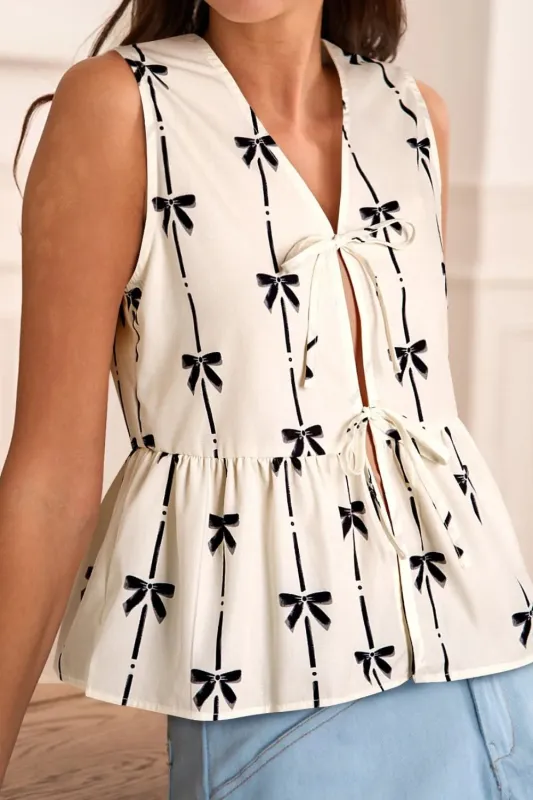 Tied Front Bow Print Peplum Tank sold by Charming Charlie