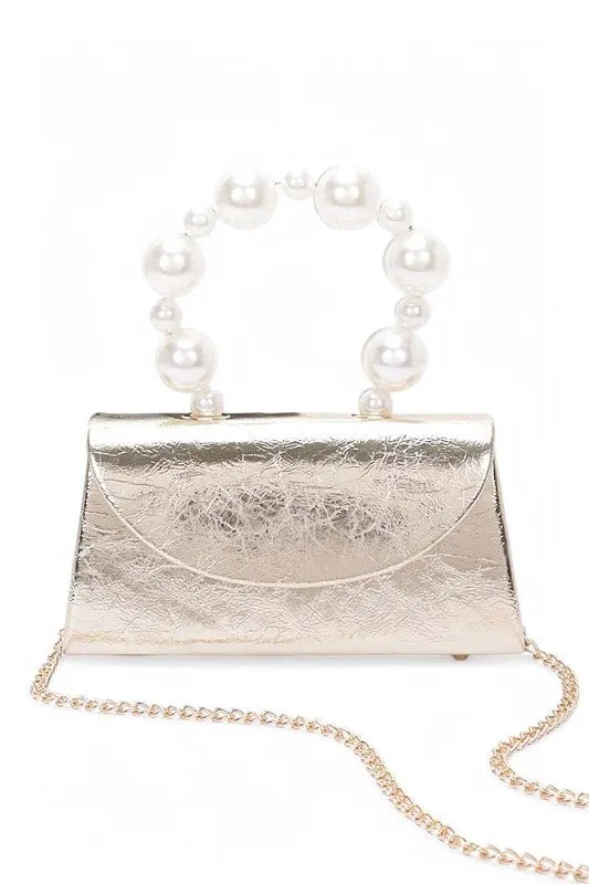 Pearl Handle Metallic Clutch Swing Bag sold by Charming Charlie