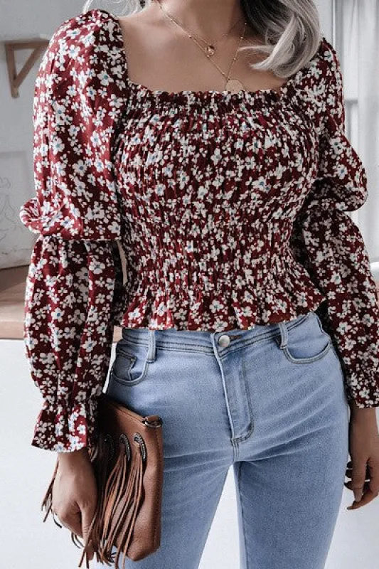 Smocked floral long sleeve top sold by Charming Charlie