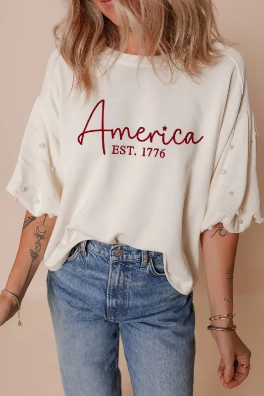 AMERICA EST 1776 Embroidered Pearl Beaded Sleeve T Shirt sold by Charming Charlie