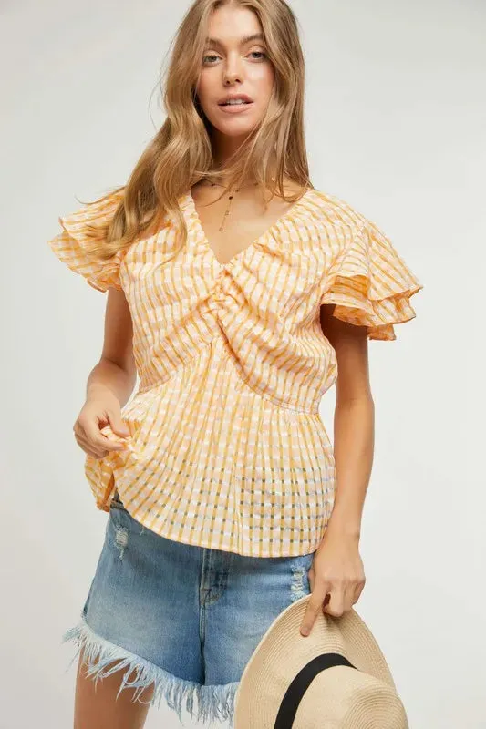 Davi & Dani Shirring V-Neck Ruffle Gingham Plaid Printed Top sold by Charming Charlie
