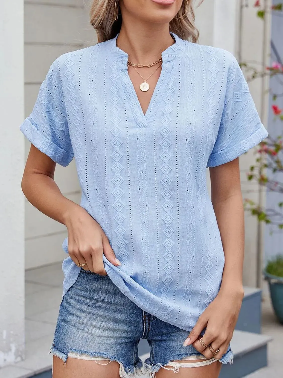 Eyelet Notched Short Sleeve Top sold by Charming Charlie
