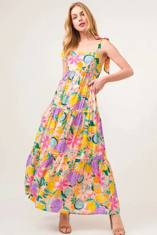 And The Why Shoulder Strap Tropical Fruit Printed Tiered Maxi Dress sold by Charming Charlie