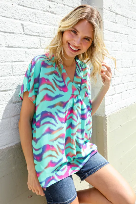Hello Beautiful Mint Wavy Animal Print Banded V Neck Top sold by Charming Charlie