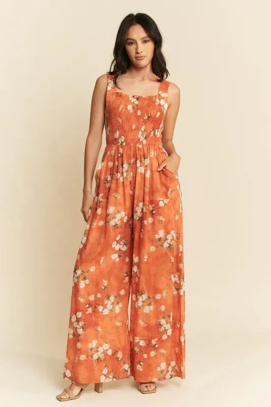 Davi & Dani Floral Ruffle Square Neck Smocking Bodice Jumpsuit sold by Charming Charlie