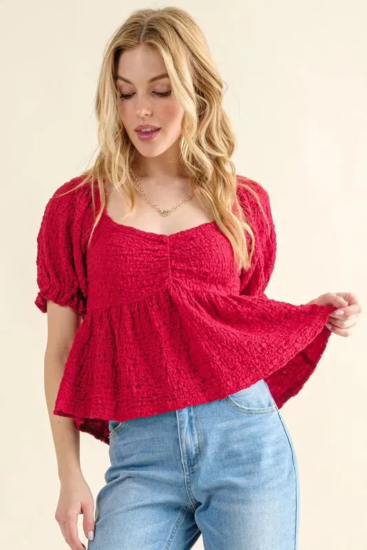 And The Why Lovely Textured and Smocked Top sold by Charming Charlie