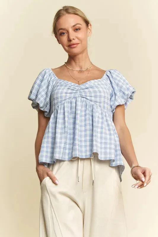 Davi & Dani Plaid Puff Sleeves Ruffled Smocked Blouse sold by Charming Charlie