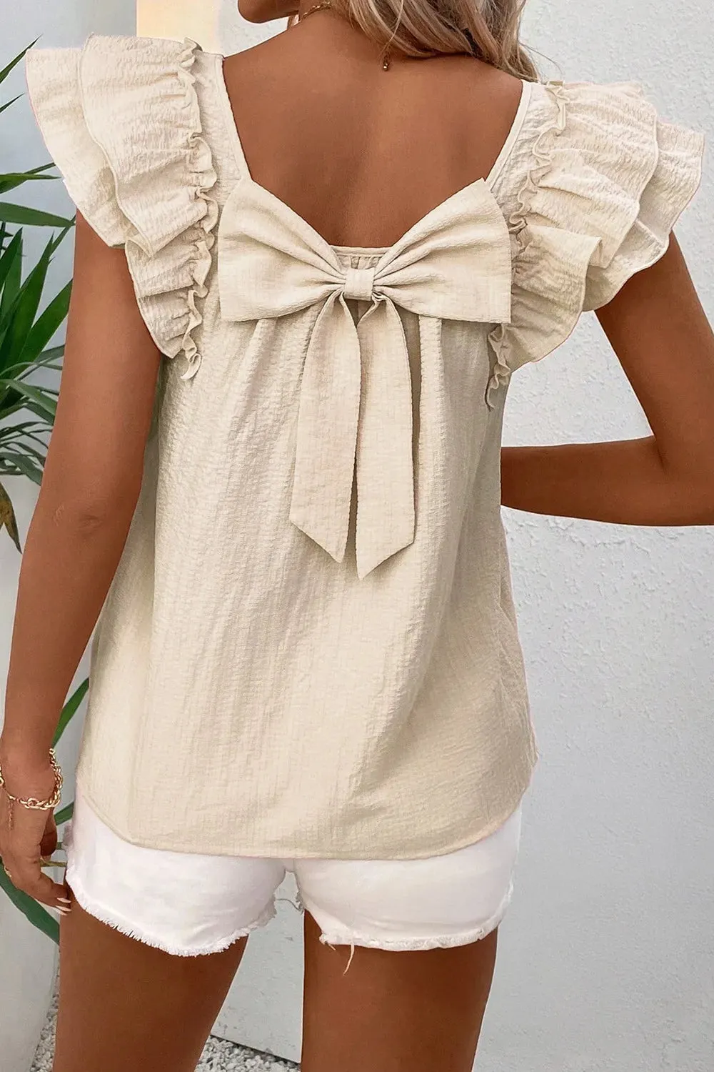 Bow Back Ruffled Cap Sleeve Blouse sold by Charming Charlie