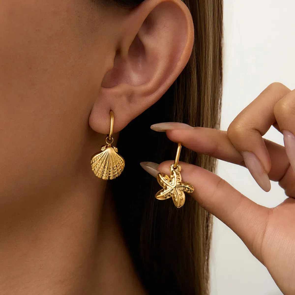 Vintage Gold Seashell & Starfish Drop Earrings sold by Charming Charlie