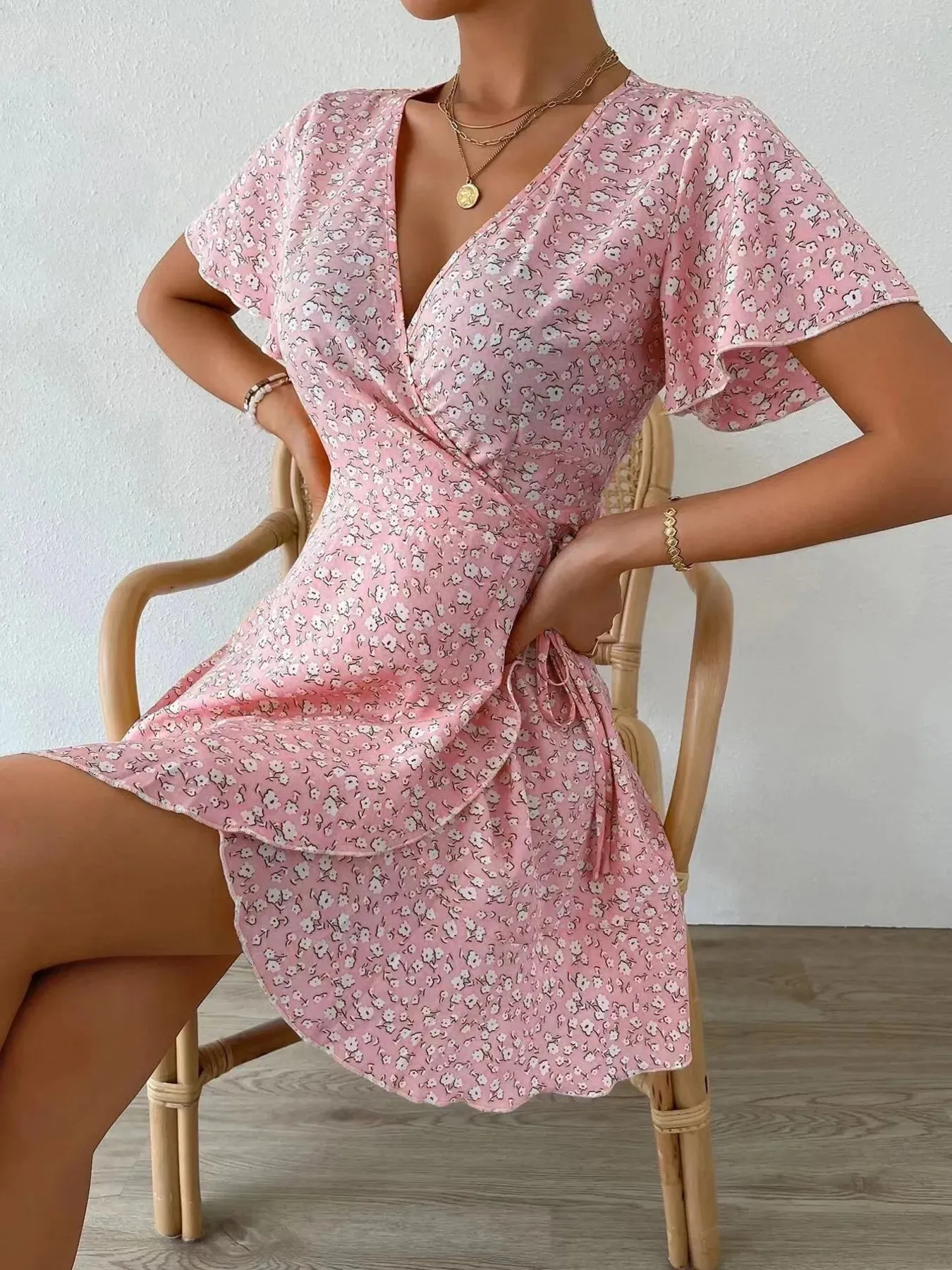 Floral Flutter Sleeve Wrap Mini Dress sold by Charming Charlie