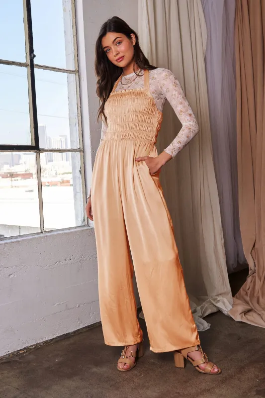 Davi & Dani Halterneck Tie Closure Smocked Bodice Jumpsuit sold by Charming Charlie