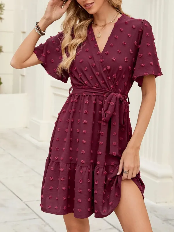 Swiss Dot Flutter Sleeve Wrap Dress sold by Charming Charlie