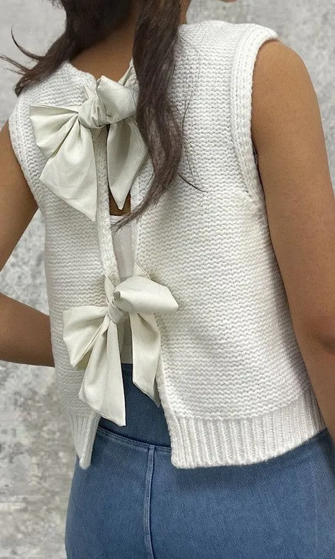 Open back bow sweater sold by Charming Charlie