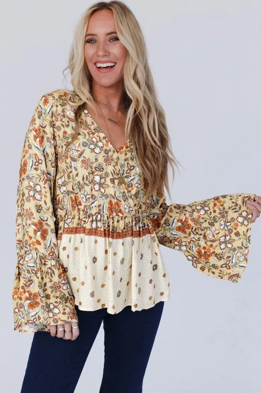 Floral V Neck Wrapped Contrast Peplum Blouse sold by Charming Charlie