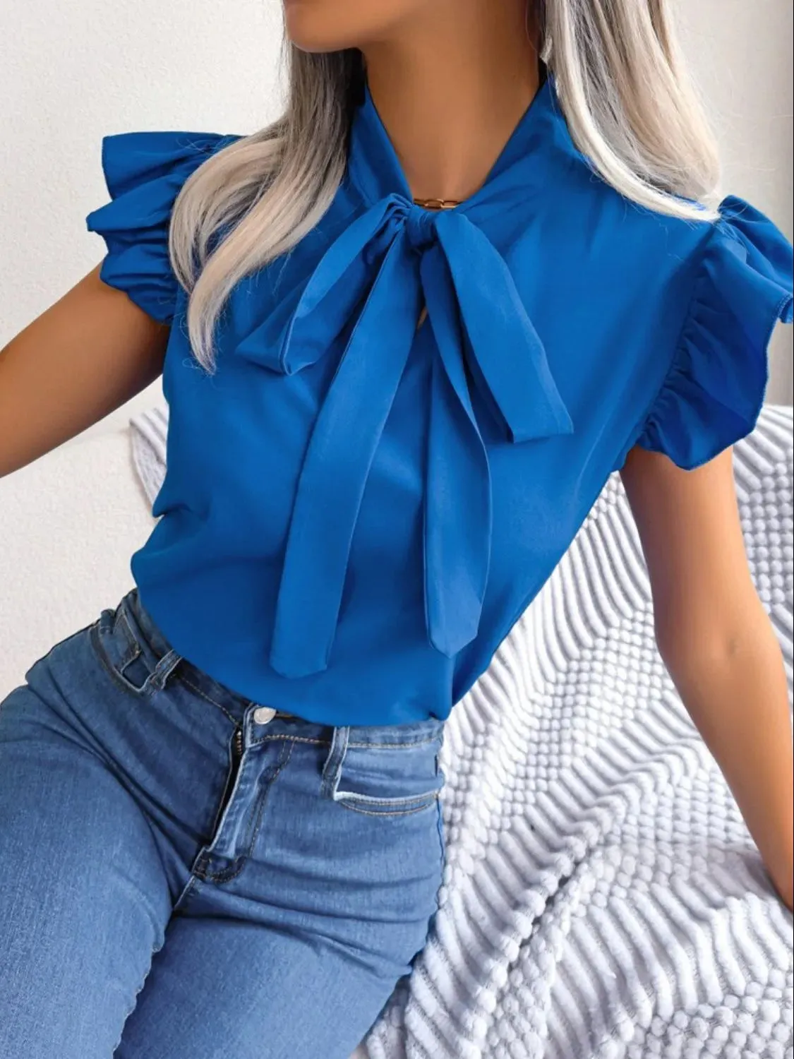 Ruffle Cap Sleeve Bow Tie Blouse sold by Charming Charlie