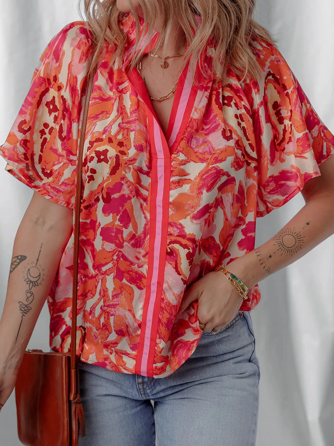 Abstract Print Striped Trim Split Neck Blouse sold by Charming Charlie