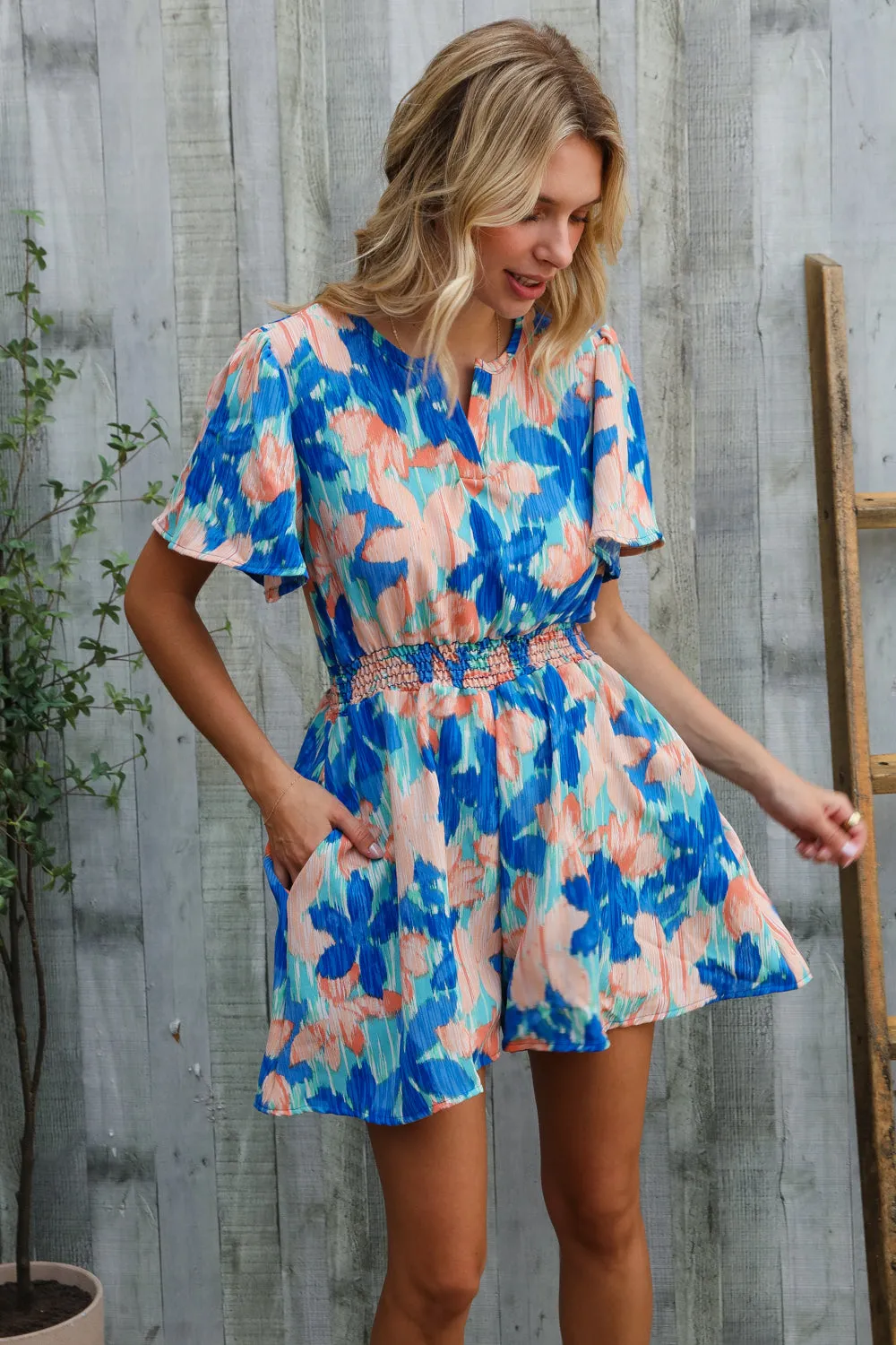Feeling Bold Turquoise Floral Smocked Waist Flutter Sleeve Romper sold by Charming Charlie product image thumbnail 4