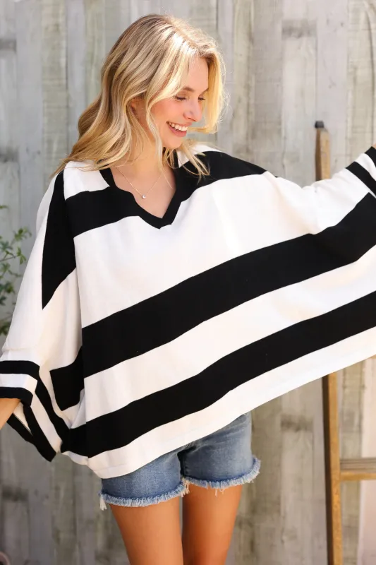The Traveler Black/White Stripe Dolman Notch Neck Sweater Poncho sold by Charming Charlie