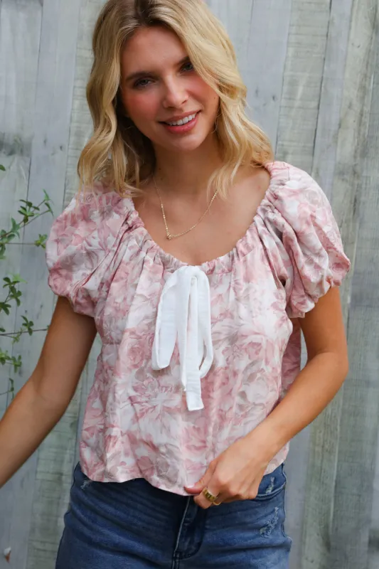 Feeling Femme' Blush Scoop Neck Floral Top w/Bow sold by Charming Charlie