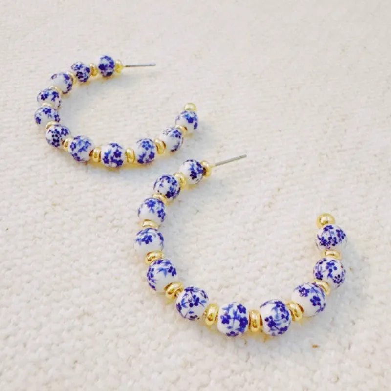 Blue Bloom Floral Hoop Earrings sold by Charming Charlie