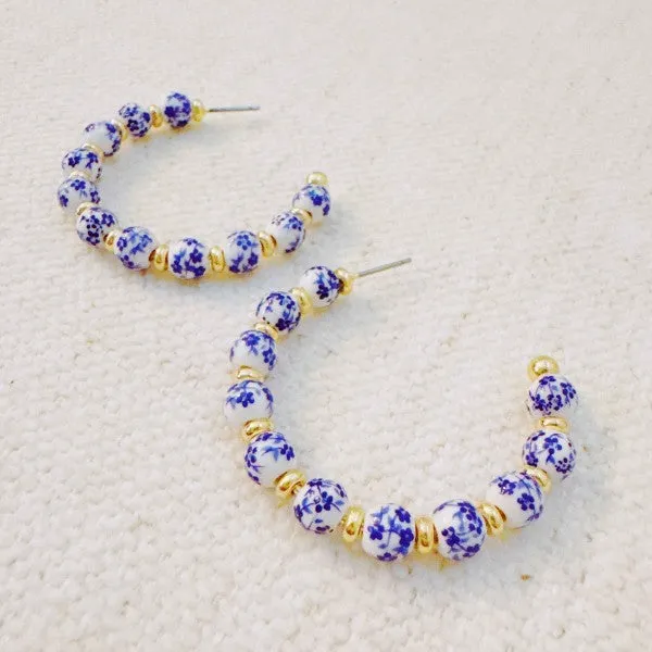Blue Bloom Floral Hoop Earrings sold by Charming Charlie