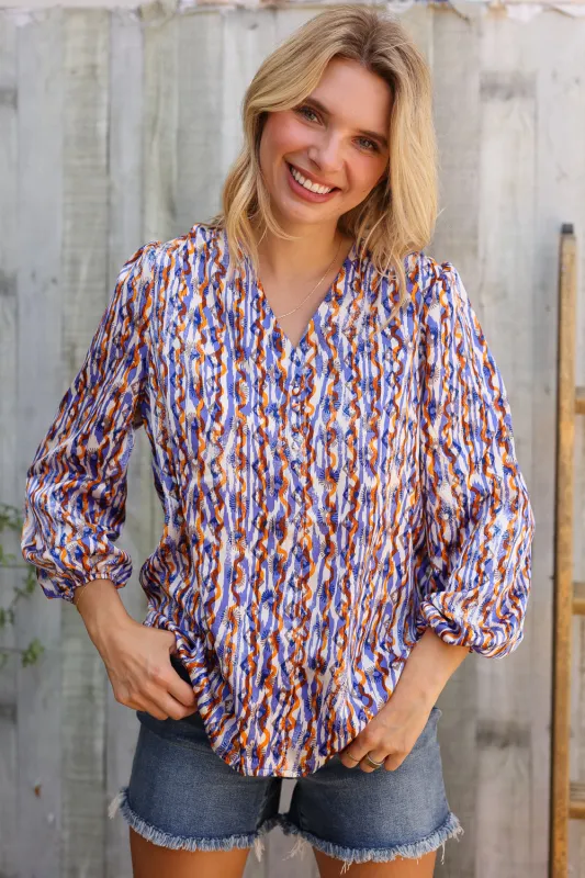 On A Wild Streak V Neck Fabric Button Detail Blouse sold by Charming Charlie