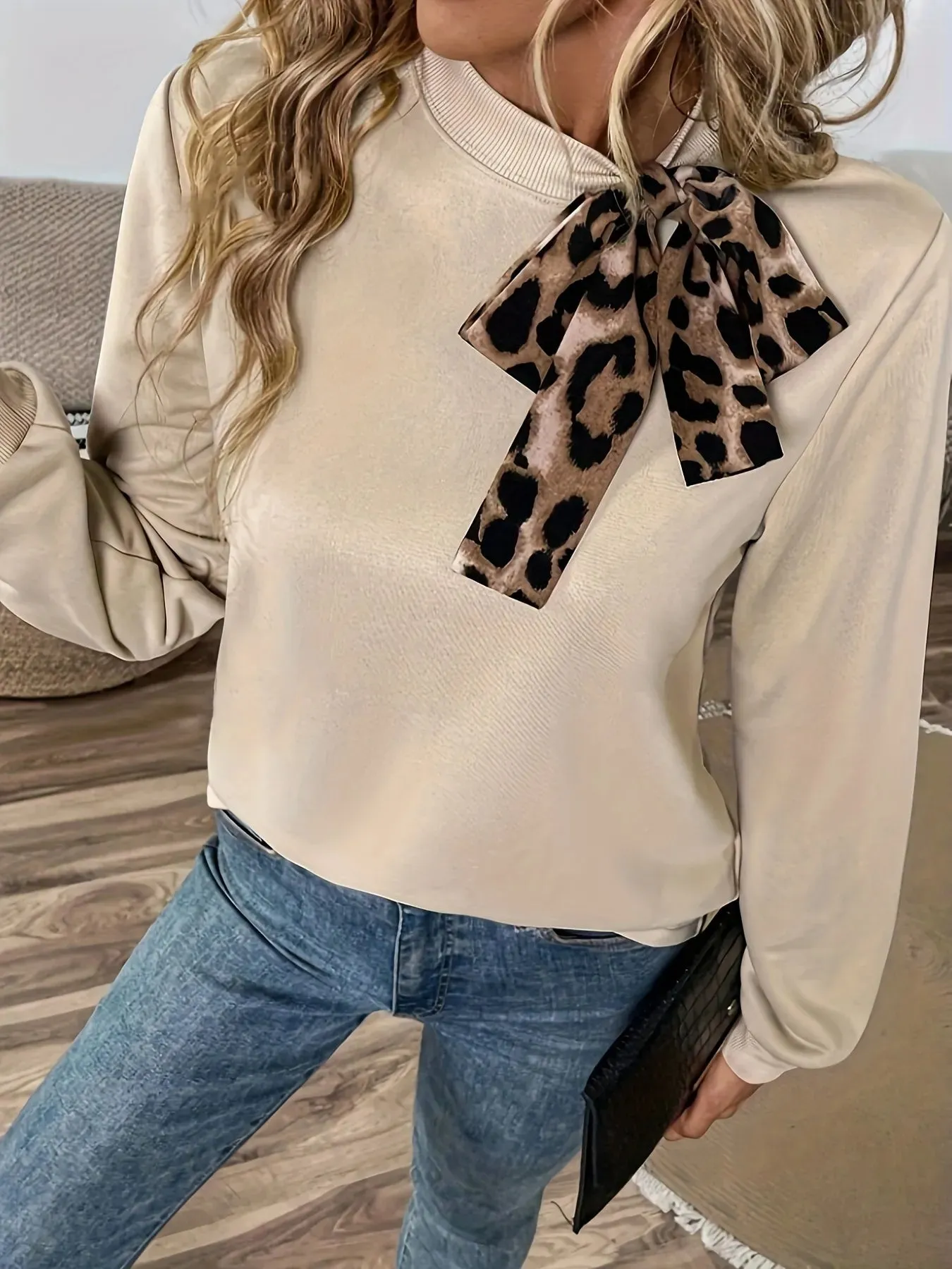Leopard Bow Tie Long Sleeve Sweatshirt sold by Charming Charlie