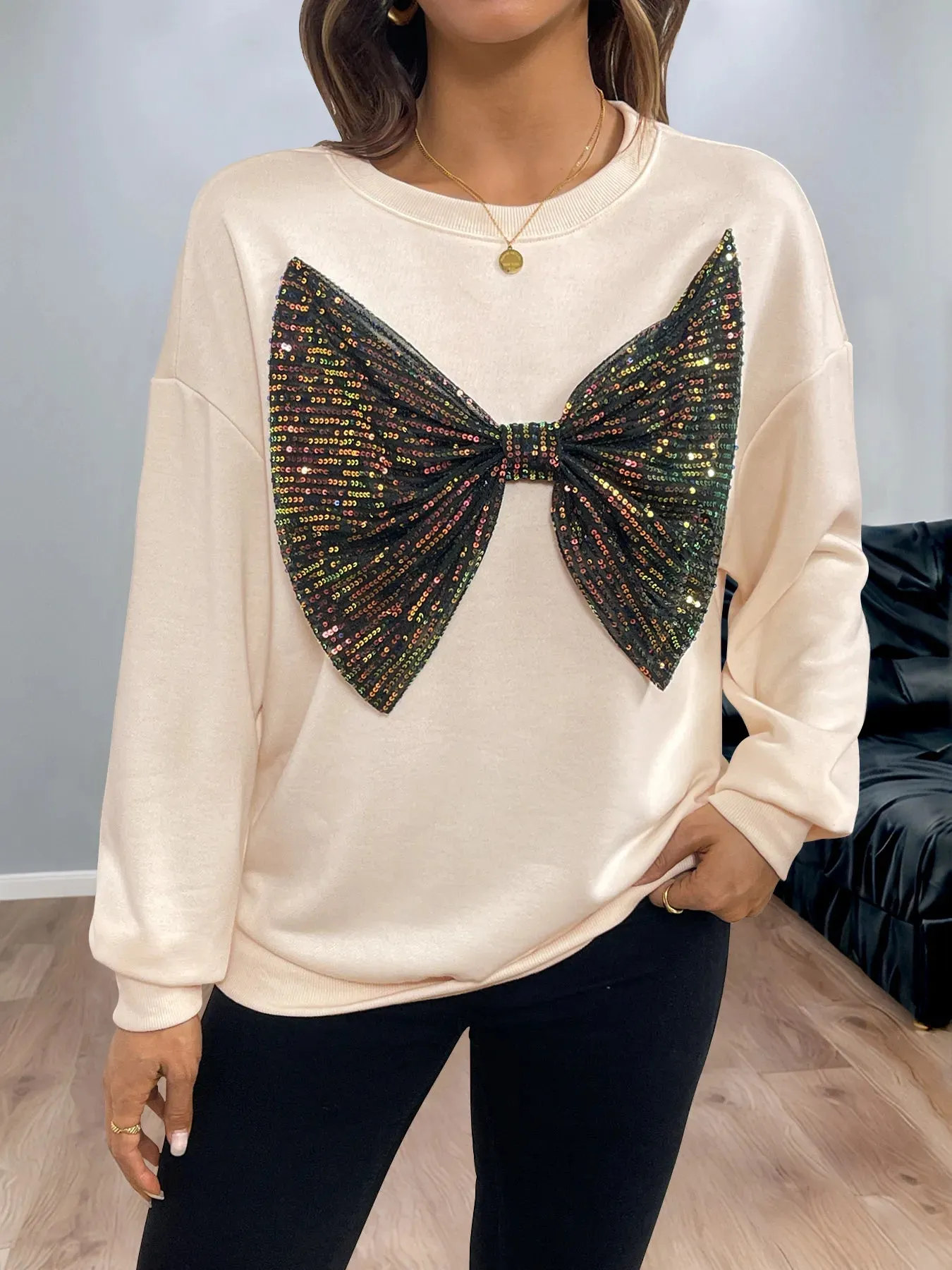 Sequined Bow Round Neck Sweatshirt sold by Charming Charlie
