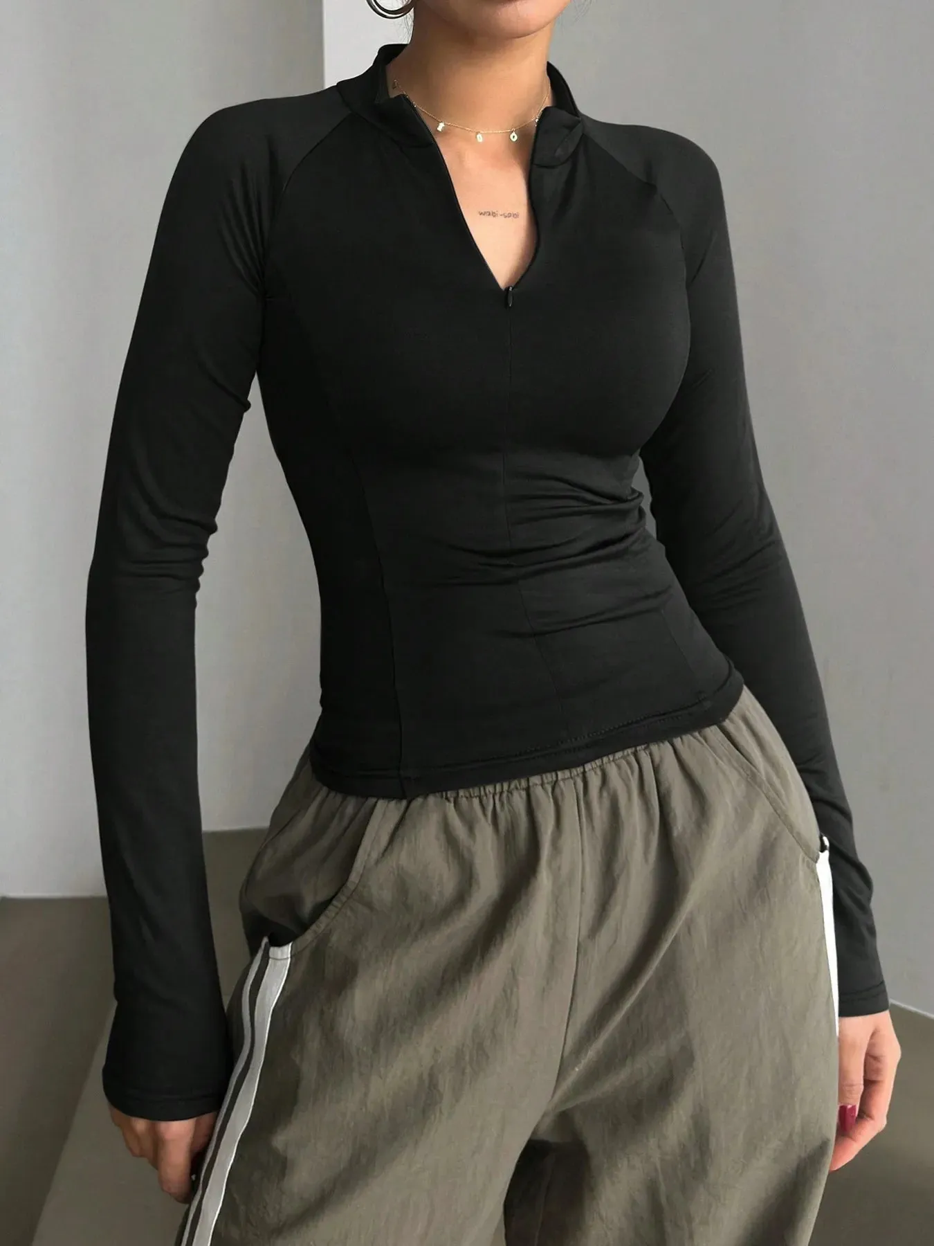 Long Sleeve Zip Front Fitted T-Shirt sold by Charming Charlie