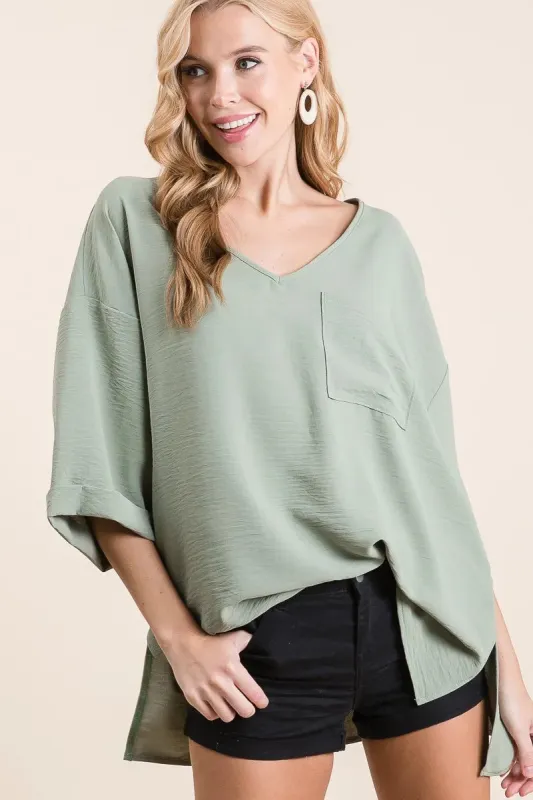 BiBi Flowy Woven V-Neck Top with Rolled Up Cuffs sold by Charming Charlie