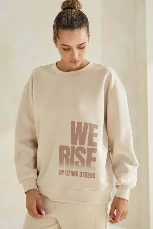 We Rise by Lifting Others Ultra Comfy Sweatshirt sold by Charming Charlie